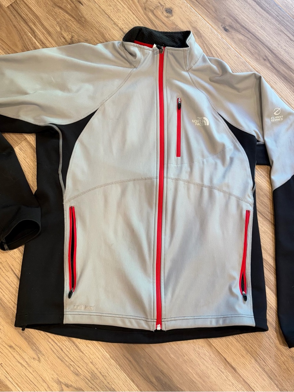 The North Face Flight Series Light Gray & Black Jacket with Red Zippers.   L.